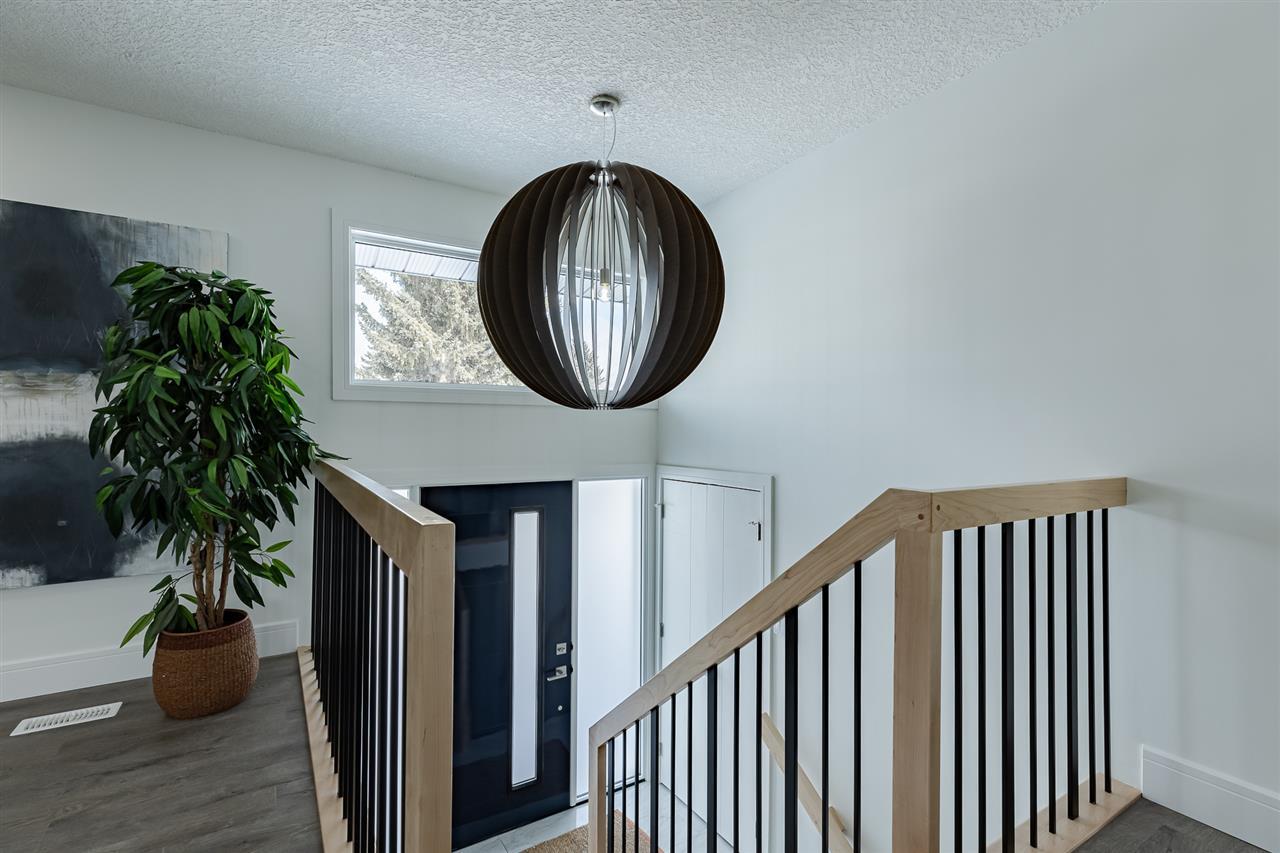 Front Entry / High Gloss Painted Door / Dramatic Light Fixture / Maple Lacquer Railings