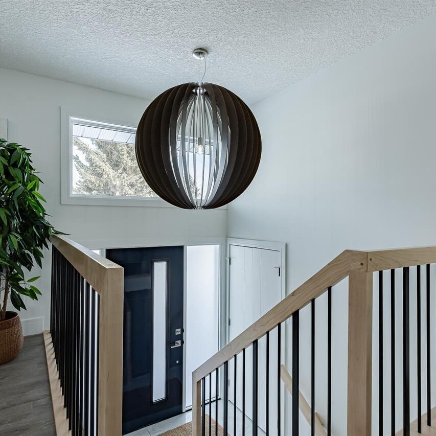 Front Entry / High Gloss Painted Door / Dramatic Light Fixture / Maple Lacquer Railings
